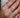 a hand wearing multiple floral dainty diamond rings