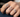 A hand wearing multiple Heart diamond rings