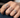 A hand wearing multiple Heart diamond rings