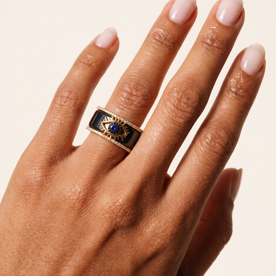 Gold Tichi Oura Ring Cap with an blue evil eye and black spinel halo