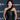 Woman in a black dress at an event with L'Oreal Paris branding.