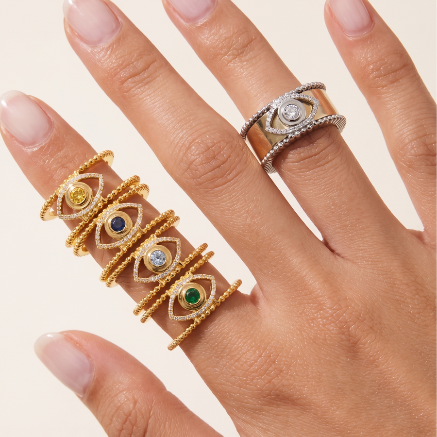 Soleil Tichi Oura Ring Cap in 18K yellow gold plating with a blue topaz, emeralds, blue topaz and yellow sapphires evil eye and moissanite halo