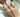 A close up of a hand with three diamond rings