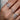a hand wearing multiple floral dainty diamond rings