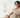 A lady sitting with multiple diamond necklaces