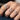 A hand wearing multiple Heart diamond rings