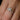 Florin flower-shaped ring on a finger with a blurred background