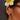 Close-up of an ear with earrings and a white flower in hair