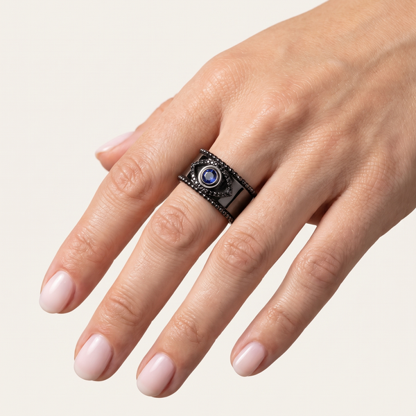 Noir Tichi Oura Ring Cap with blue sapphire on a black Oura