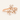 Rose gold ring with diamond floral design on a light beige background