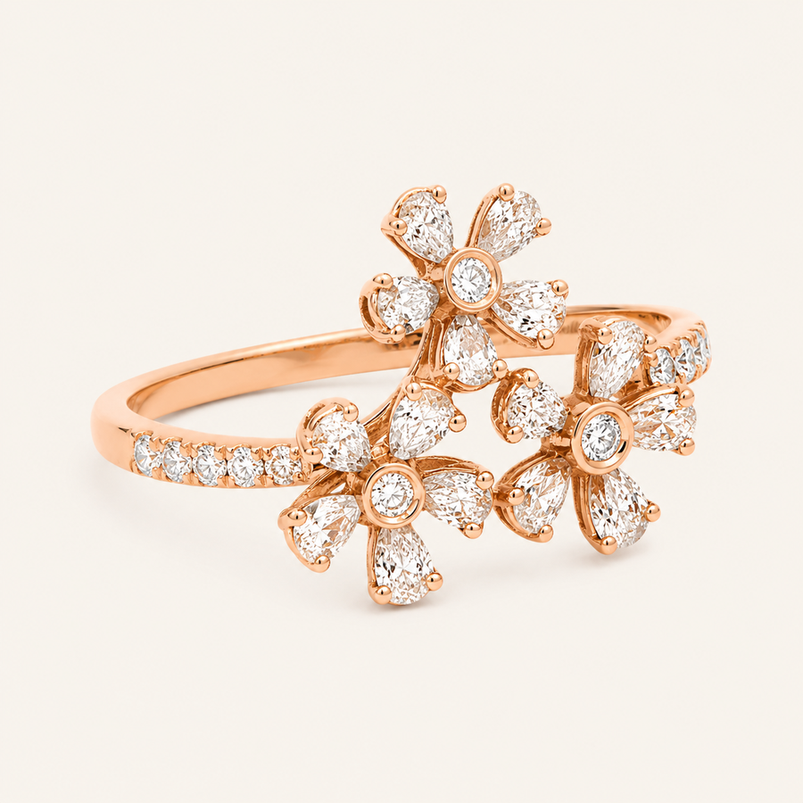 Rose gold ring with diamond floral design on a light beige background
