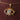 Gold pendant with eye design on a chain against a brown fabric background - Psylish