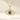 Gold necklace with an eye-shaped pendant featuring a blue gemstone on a beige background