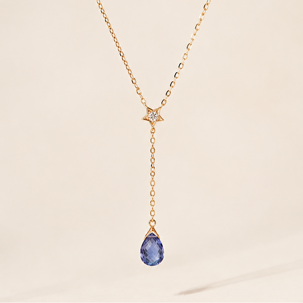 Gold necklace with a blue briolette teardrop pendant